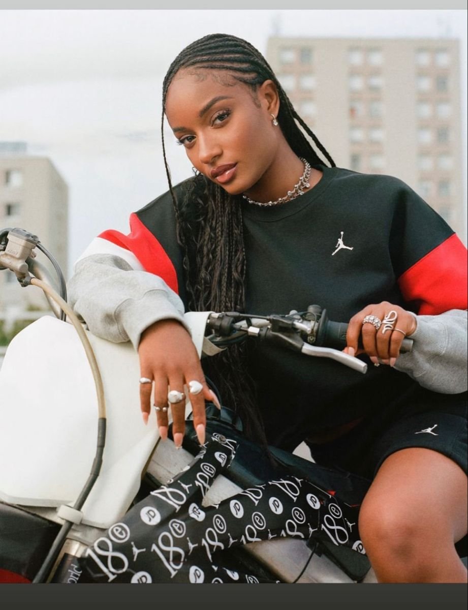 Ayra Starr on a bike